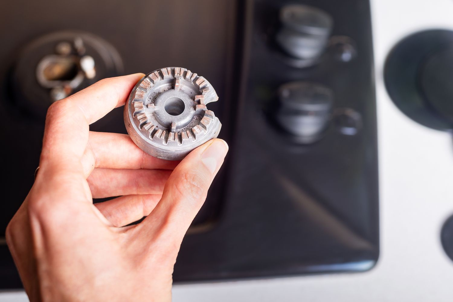 Cleaning clogged burner ports on an oven