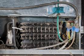 Cleaning the condenser coils of a Scotsman refrigerator